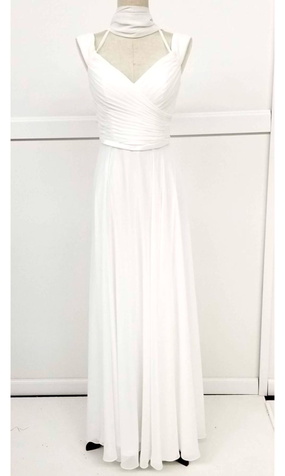 The Long A-Line Off-Shoulder Prom Dress: Chicas C8997, a white floor-length formal gown with a flowy skirt, is displayed on a dress form against a plain background.